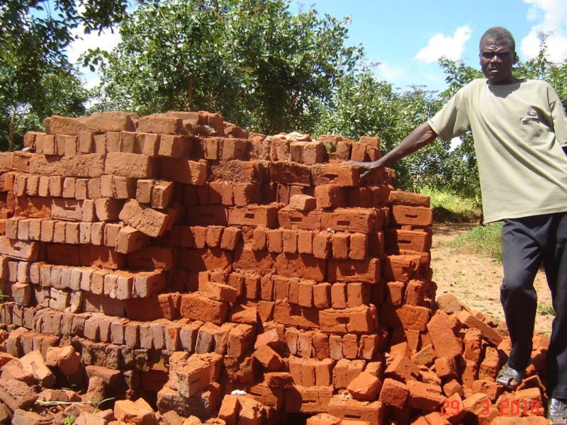 Bricks for the school library and teachers office project moulded by the community.