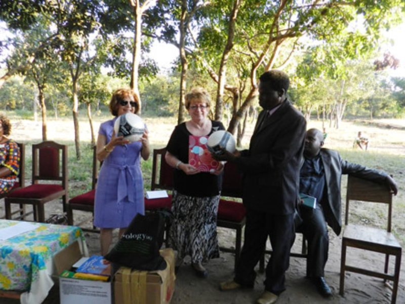 Guest of honour, Mrs. Enzi, donated assorted items to the library on behalf of the American people which were received by the Head teacher of the Chimvite Primary School (right).